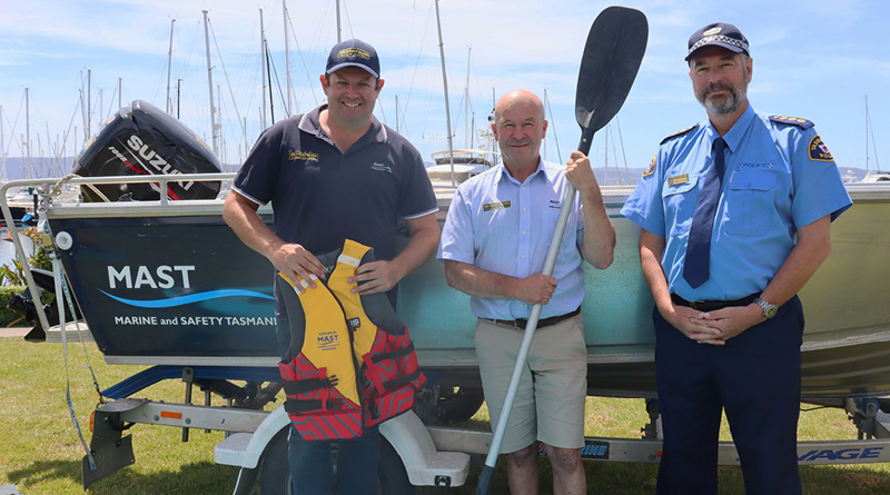 MAST ambassador Andrew Hart, MAST manager of recreational boating Peter Hopkins and Tasmania Police acting Inspector for Marine and Rescue Services Justin Lawson standing in front of a boat.